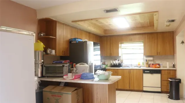 a kitchen with a sink stove and refrigerator