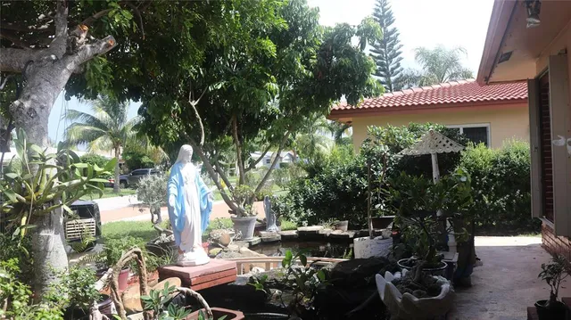 a view of a patio with table and chairs and potted plants