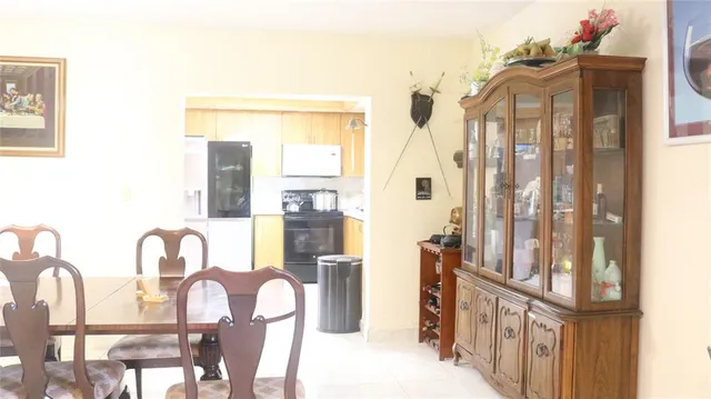 a view of a dining room with furniture and a window