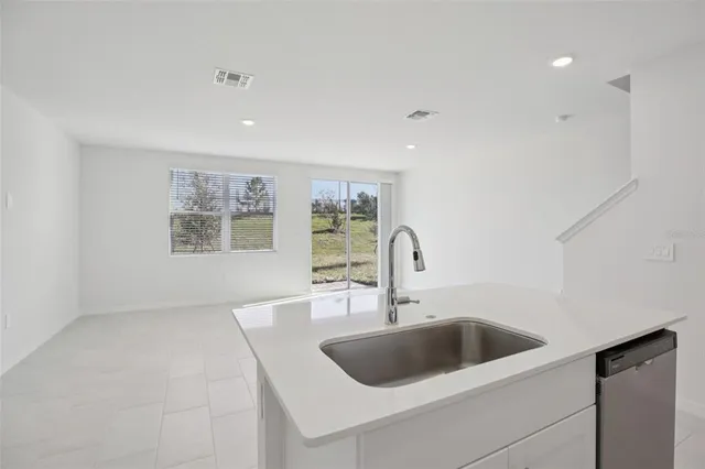 a kitchen with a sink and a refrigerator