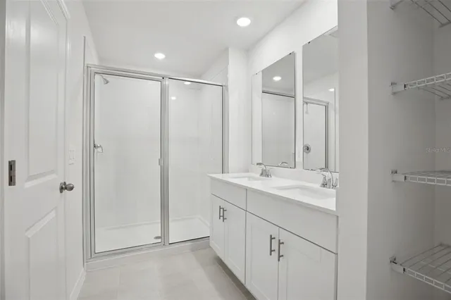 a bathroom with a double vanity sink and mirror