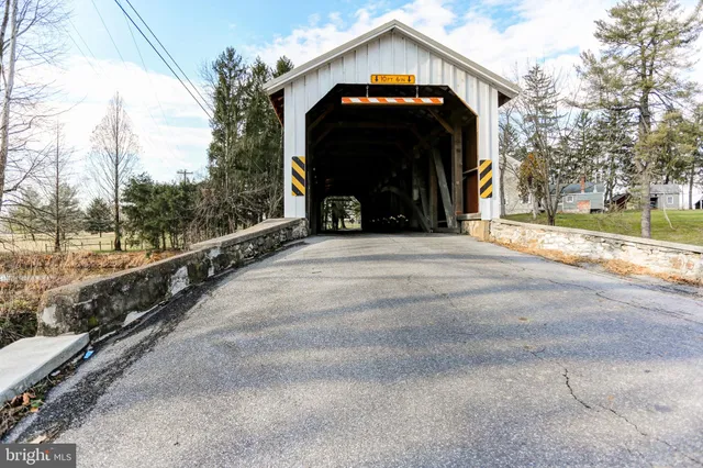 an aerial view of a house with yard swimming pool and outdoor seating