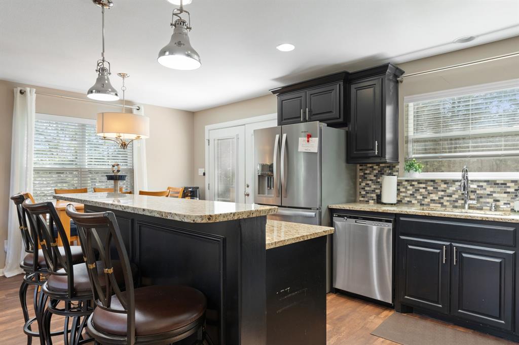 150 Spanish Trail Pottsboro, TX 75076 - Photo 12 of 36 a kitchen with stainless steel appliances a table chairs refrigerator and sink