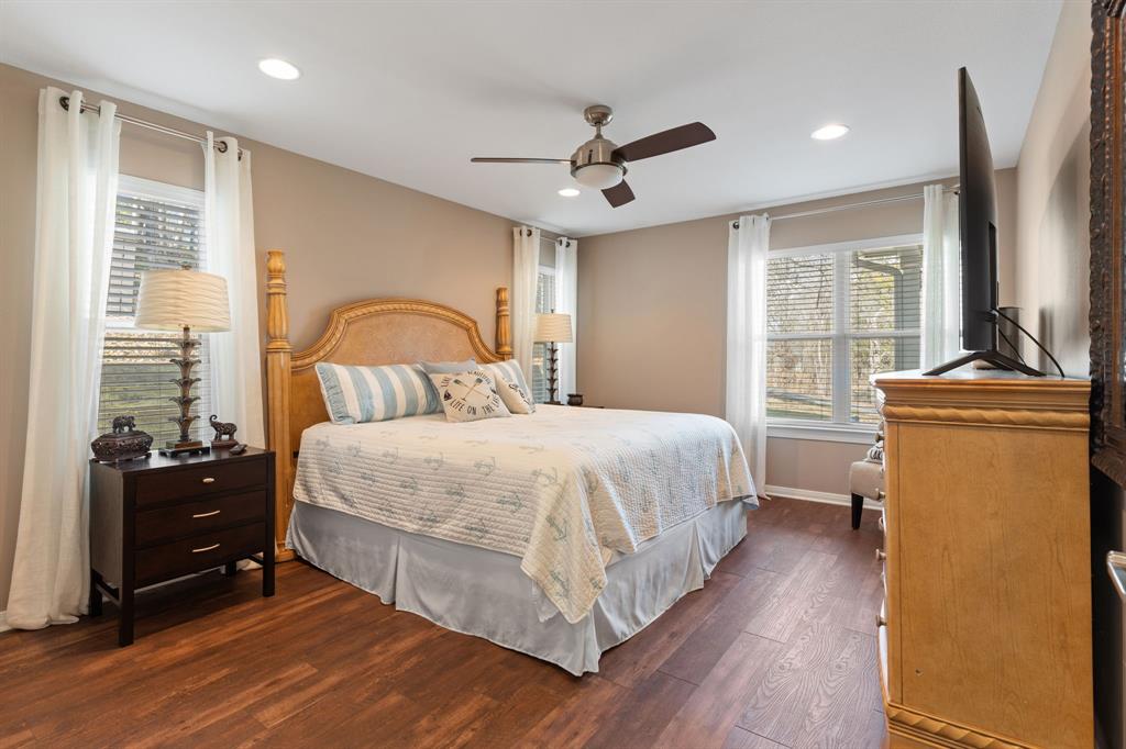 150 Spanish Trail Pottsboro, TX 75076 - Photo 14 of 36 a bedroom with a bed and wooden floor