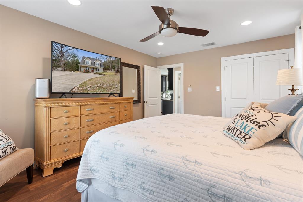 150 Spanish Trail Pottsboro, TX 75076 - Photo 15 of 36 a bedroom with a bed and a flat screen tv