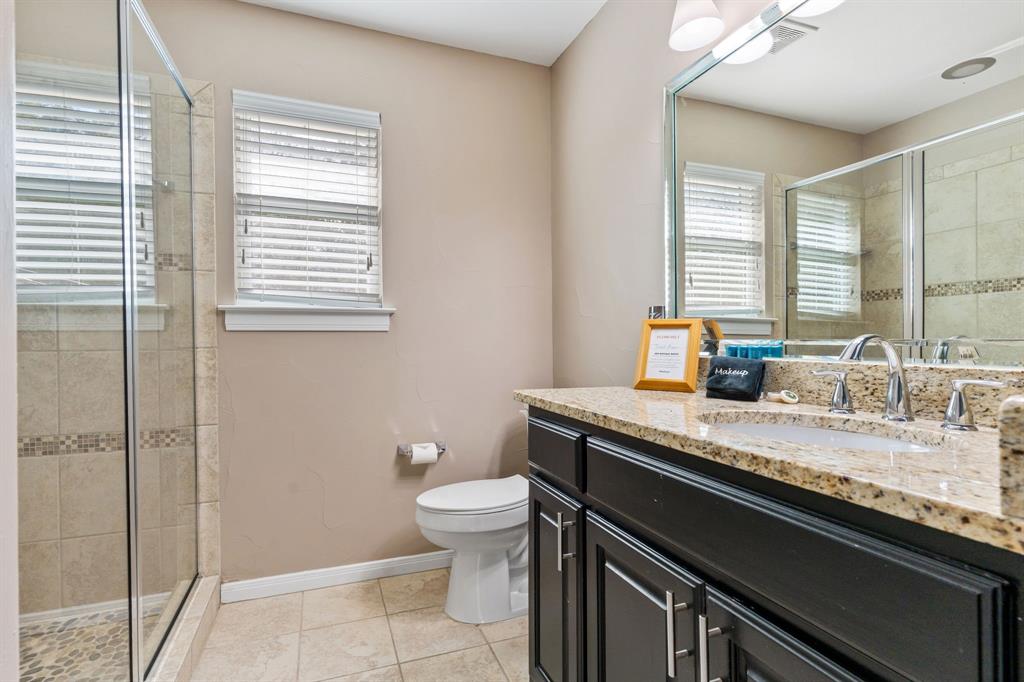 150 Spanish Trail Pottsboro, TX 75076 - Photo 19 of 36 a bath room with a sink a toilet and next to a window