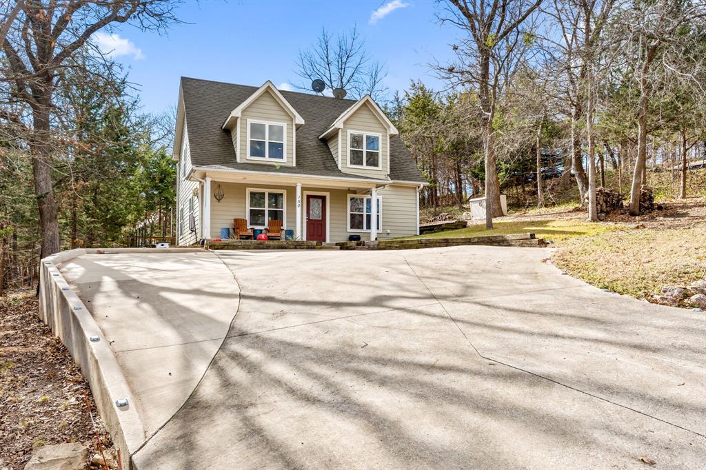 150 Spanish Trail Pottsboro, TX 75076 - Photo 2 of 36 a front view of a house with a yard