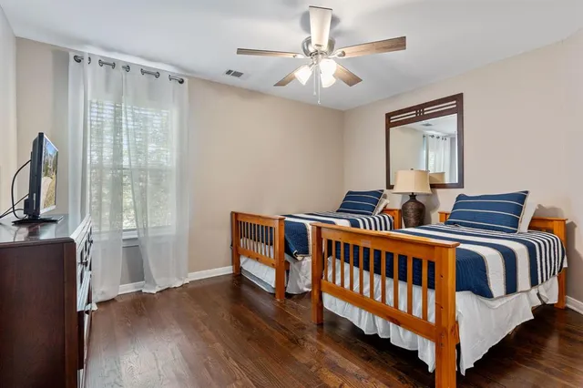a bedroom with furniture and wooden floor