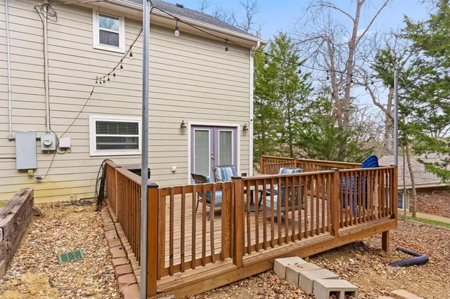 a view of a wooden house with a small yard