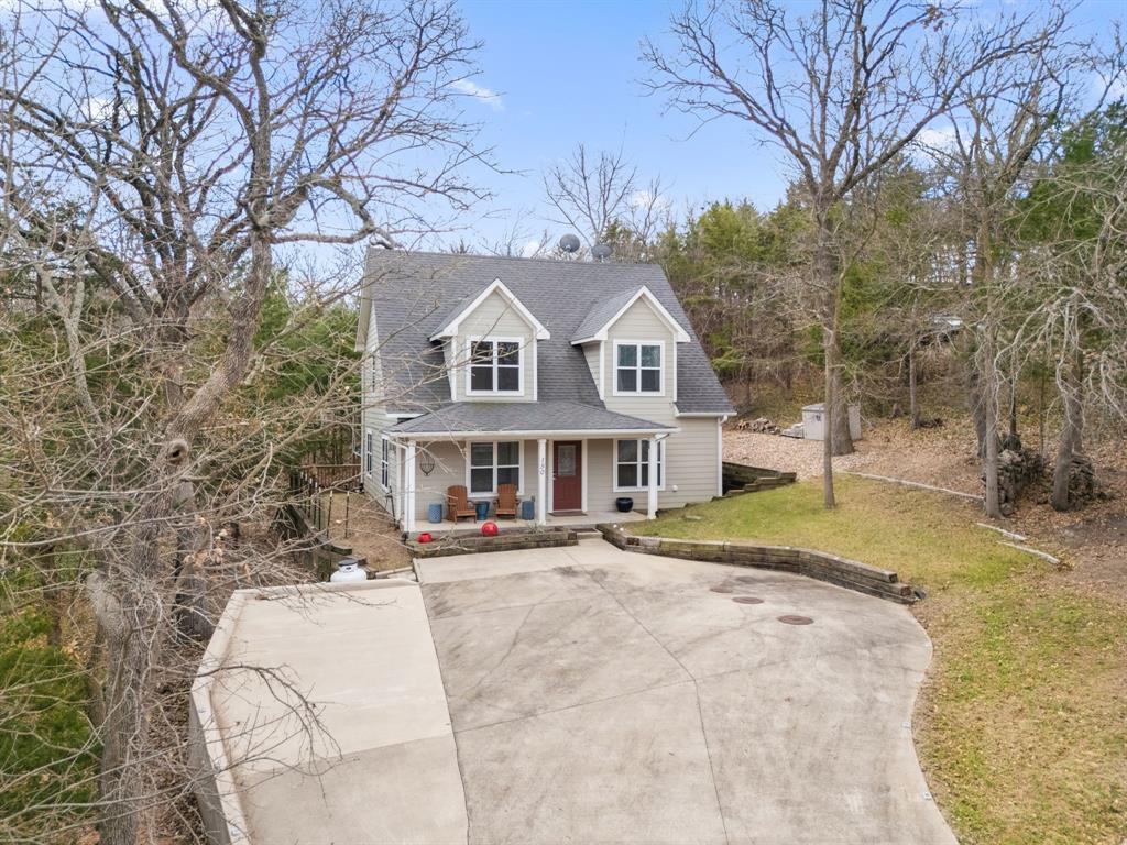 150 Spanish Trail Pottsboro, TX 75076 - Photo 29 of 36 a front view of a house with a yard