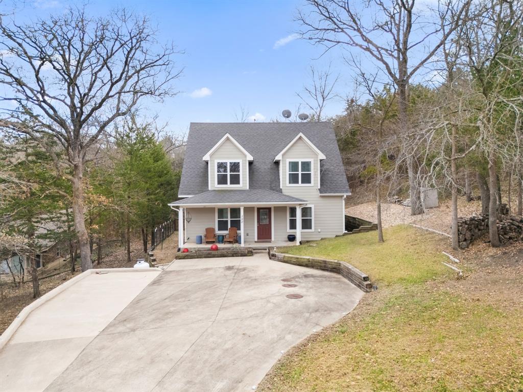 150 Spanish Trail Pottsboro, TX 75076 - Photo 30 of 36 a front view of a house with a yard