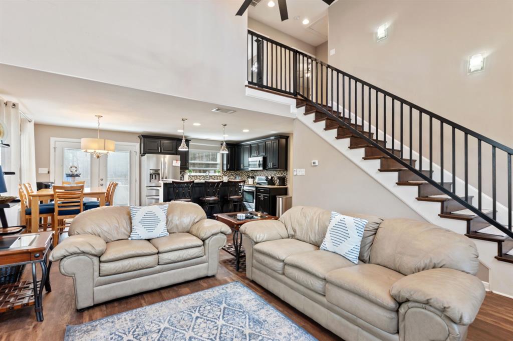 150 Spanish Trail Pottsboro, TX 75076 - Photo 7 of 36 a living room with furniture kitchen view and a wooden floor