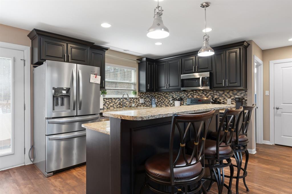 150 Spanish Trail Pottsboro, TX 75076 - Photo 8 of 36 a kitchen with kitchen island granite countertop a sink stove and refrigerator