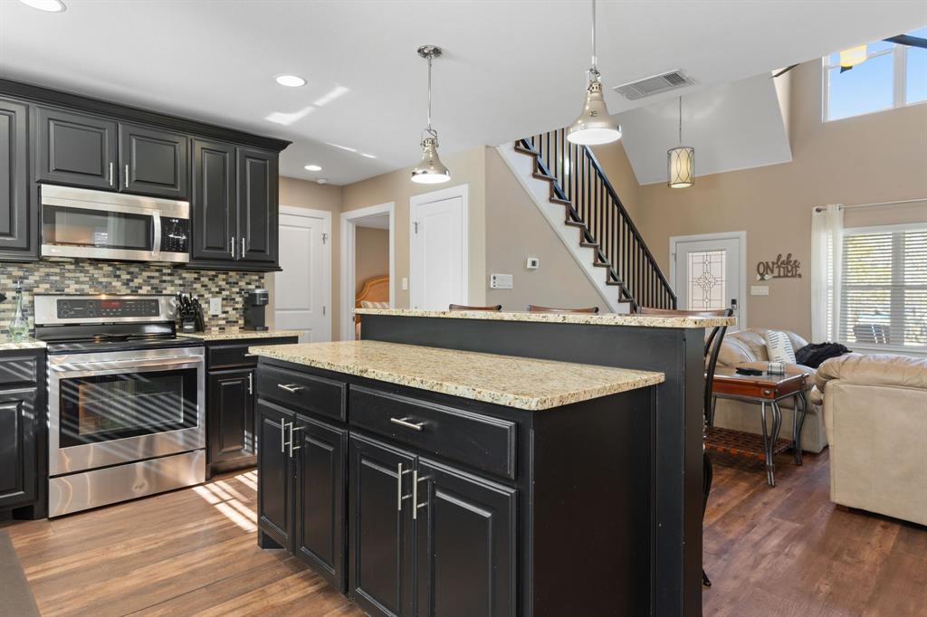 150 Spanish Trail Pottsboro, TX 75076 - Photo 9 of 36 a kitchen with a stove sink and cabinets