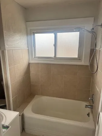 a bath tub sitting next to a window