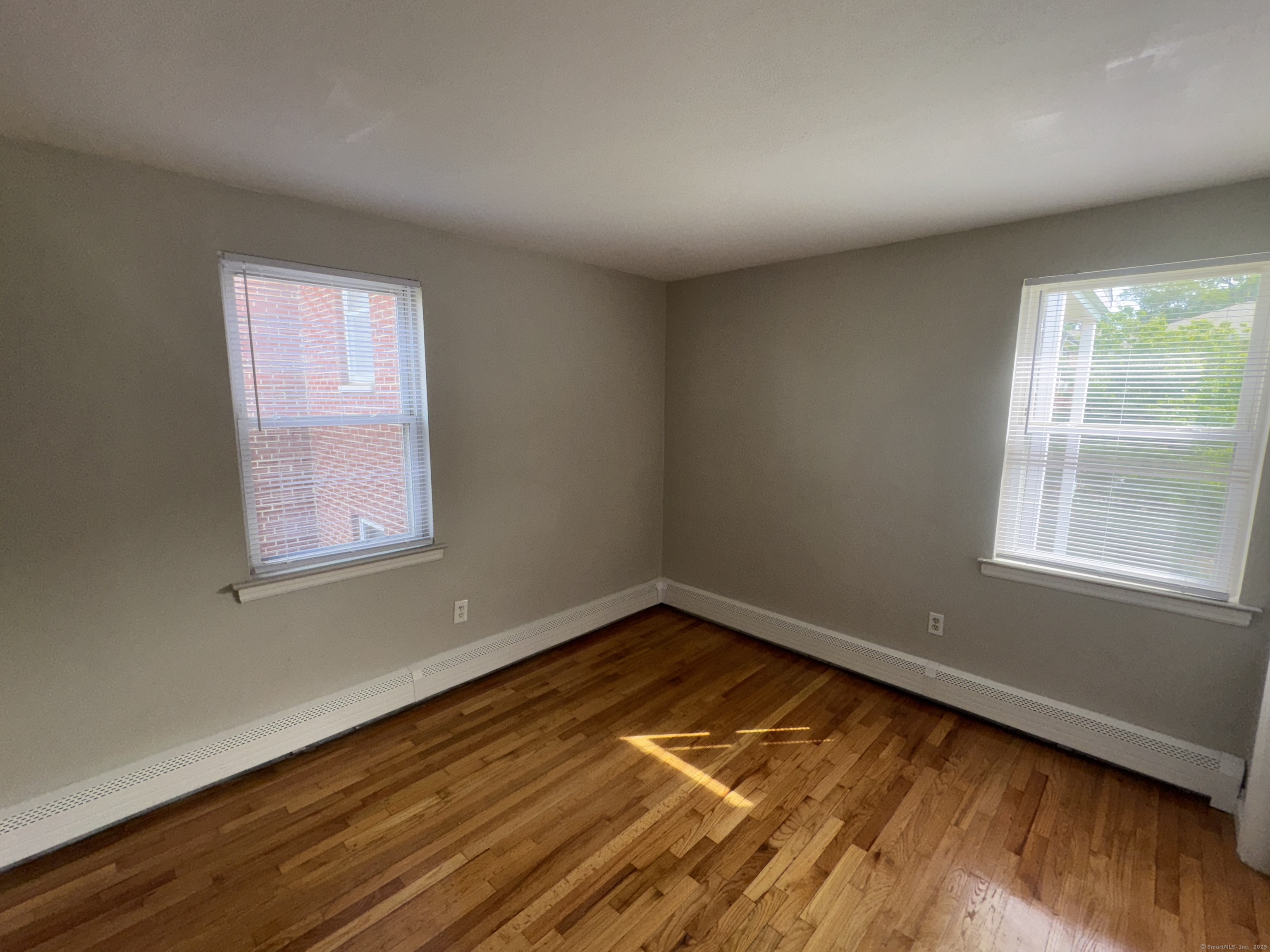 768 New Britain Avenue, Unit 2 Hartford, CT 06106 - Photo 11 of 17 a view of empty room with wooden floor and fan