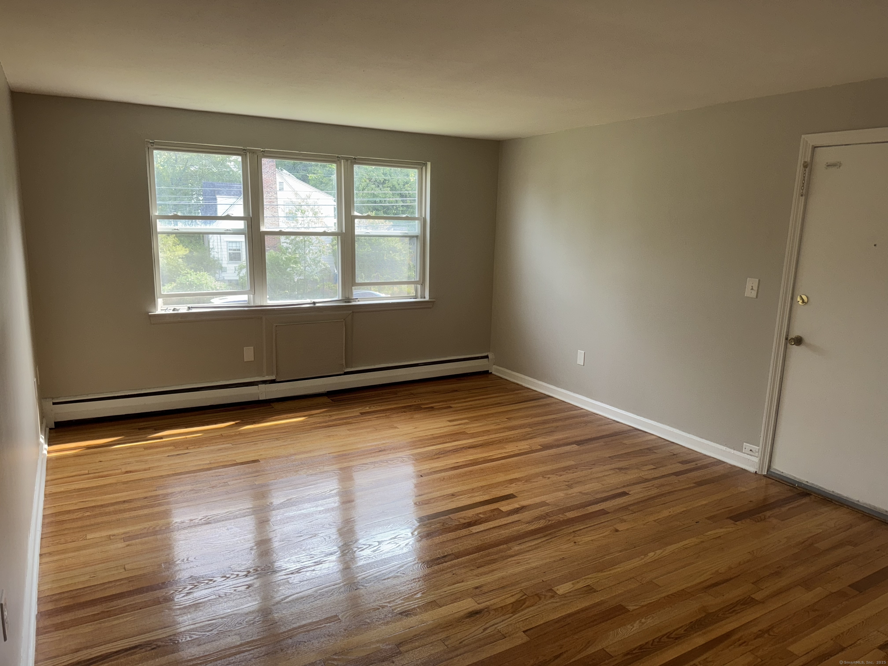 768 New Britain Avenue, Unit 2 Hartford, CT 06106 - Photo 12 of 17 a view of empty room with wooden floor and fan