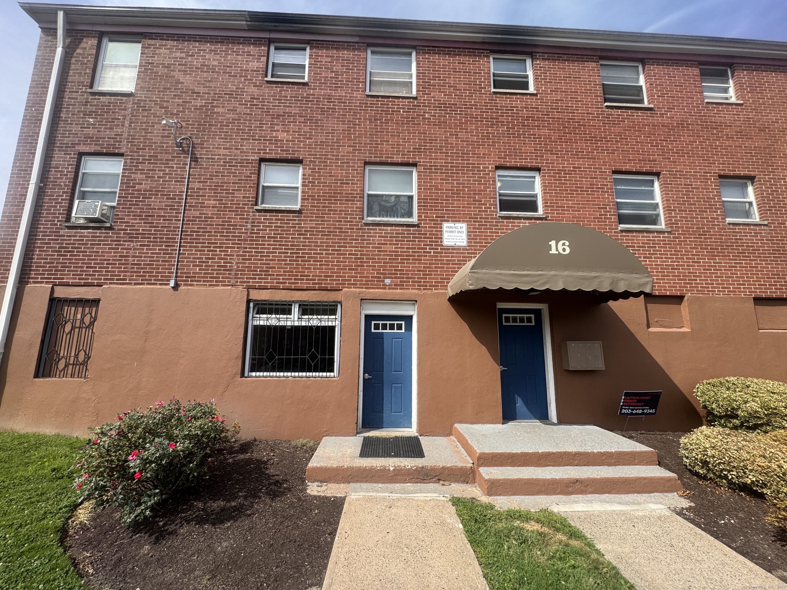 768 New Britain Avenue, Unit 2 Hartford, CT 06106 - Photo 13 of 17 a front view of a house with a yard