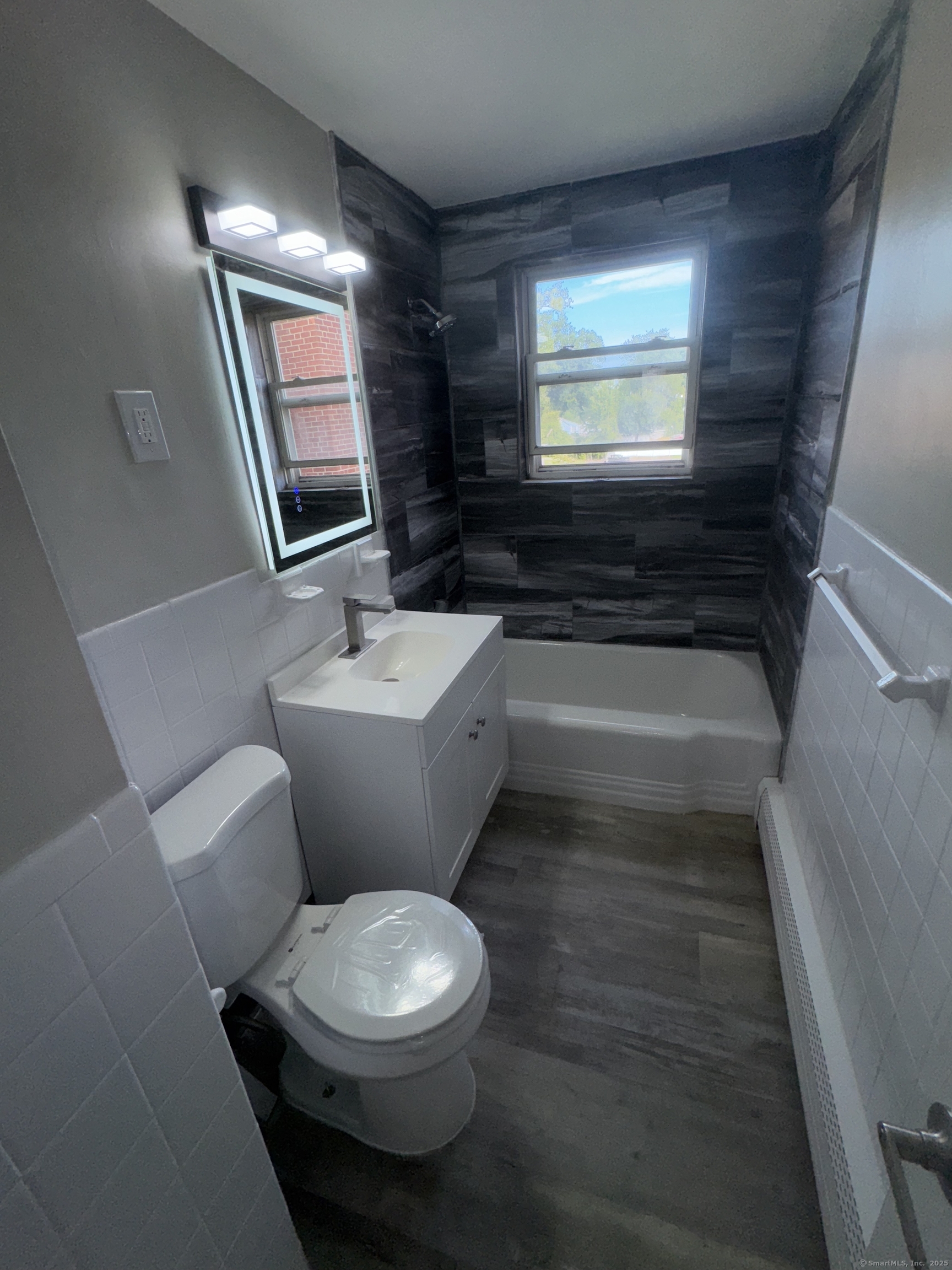 768 New Britain Avenue, Unit 2 Hartford, CT 06106 - Photo 8 of 17 a bathroom with a toilet a sink and a mirror