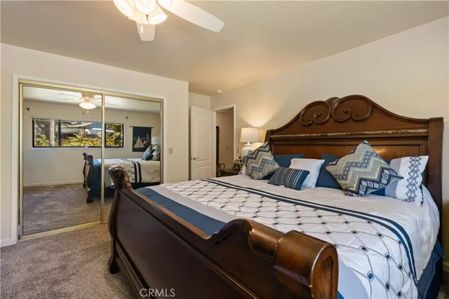 a bathroom with a granite countertop sink mirror and toilet