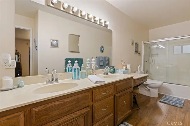 a bedroom with a bed a window and a flat screen television