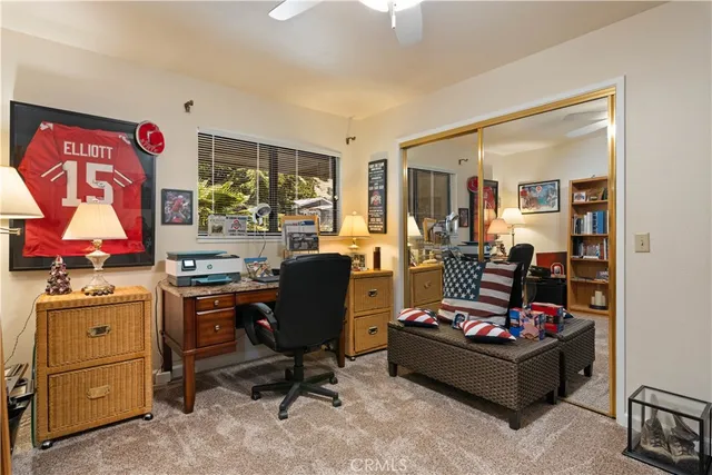 a bedroom with a bed and a flat tv screen on wall