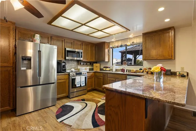 a kitchen with stainless steel appliances a refrigerator and a microwave