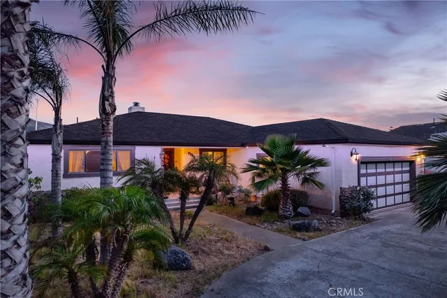 a small pool with table and chairs under an umbrella