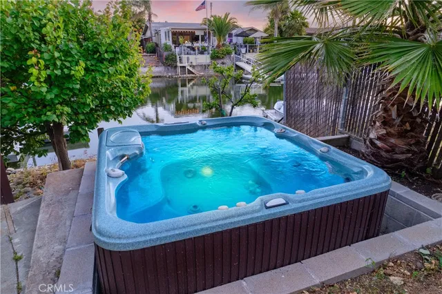 a aerial view of a house with swimming pool garden view and lake view