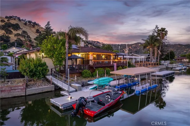 an aerial view of a house with outdoor space and lake view