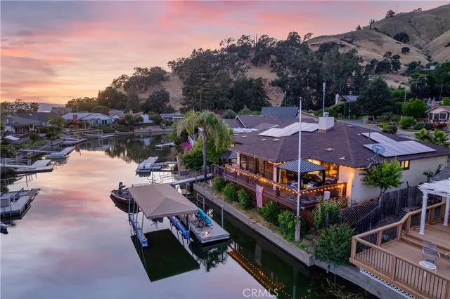 a view of a house with swimming pool and sitting area