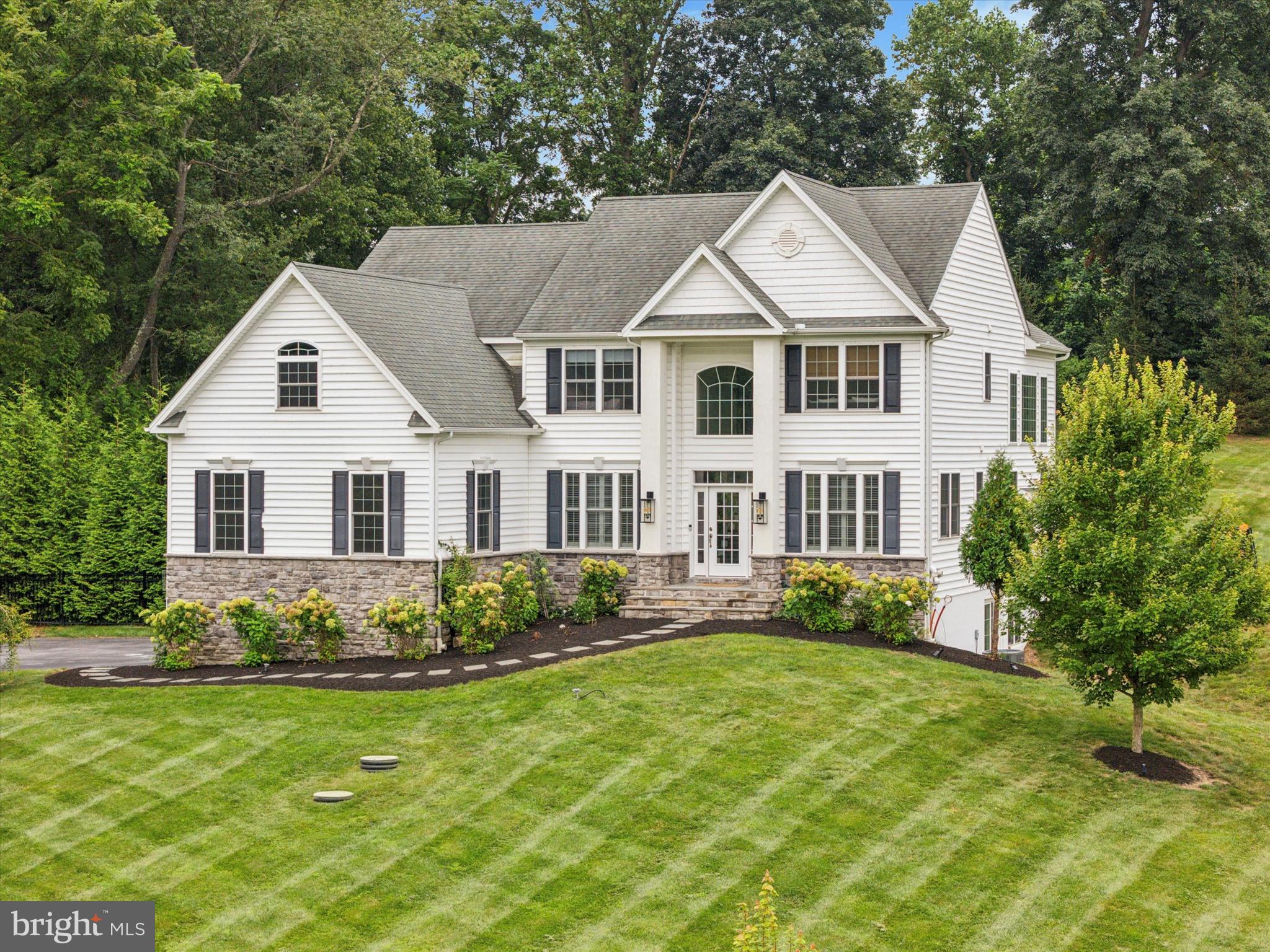 a view of a white house with a yard and plants