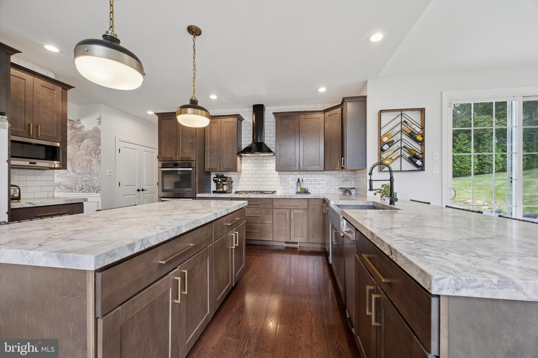 1444 Telegraph Road West Chester, PA 19380 - Photo 12 of 63 a kitchen with stainless steel appliances granite countertop a sink dishwasher a stove and a kitchen island with wooden floor