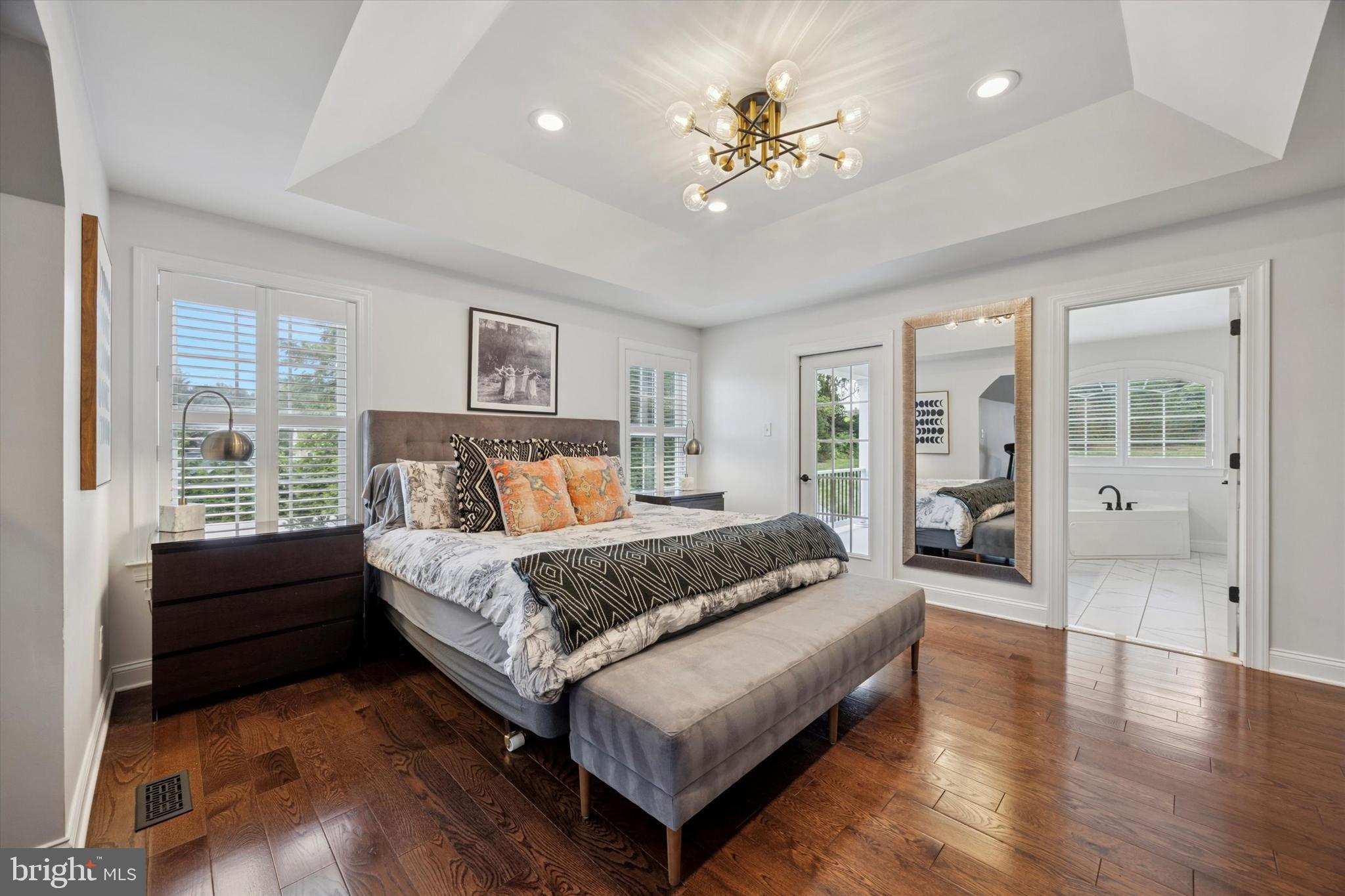 1444 Telegraph Road West Chester, PA 19380 - Photo 29 of 63 a spacious bedroom with a large bed and a chandelier