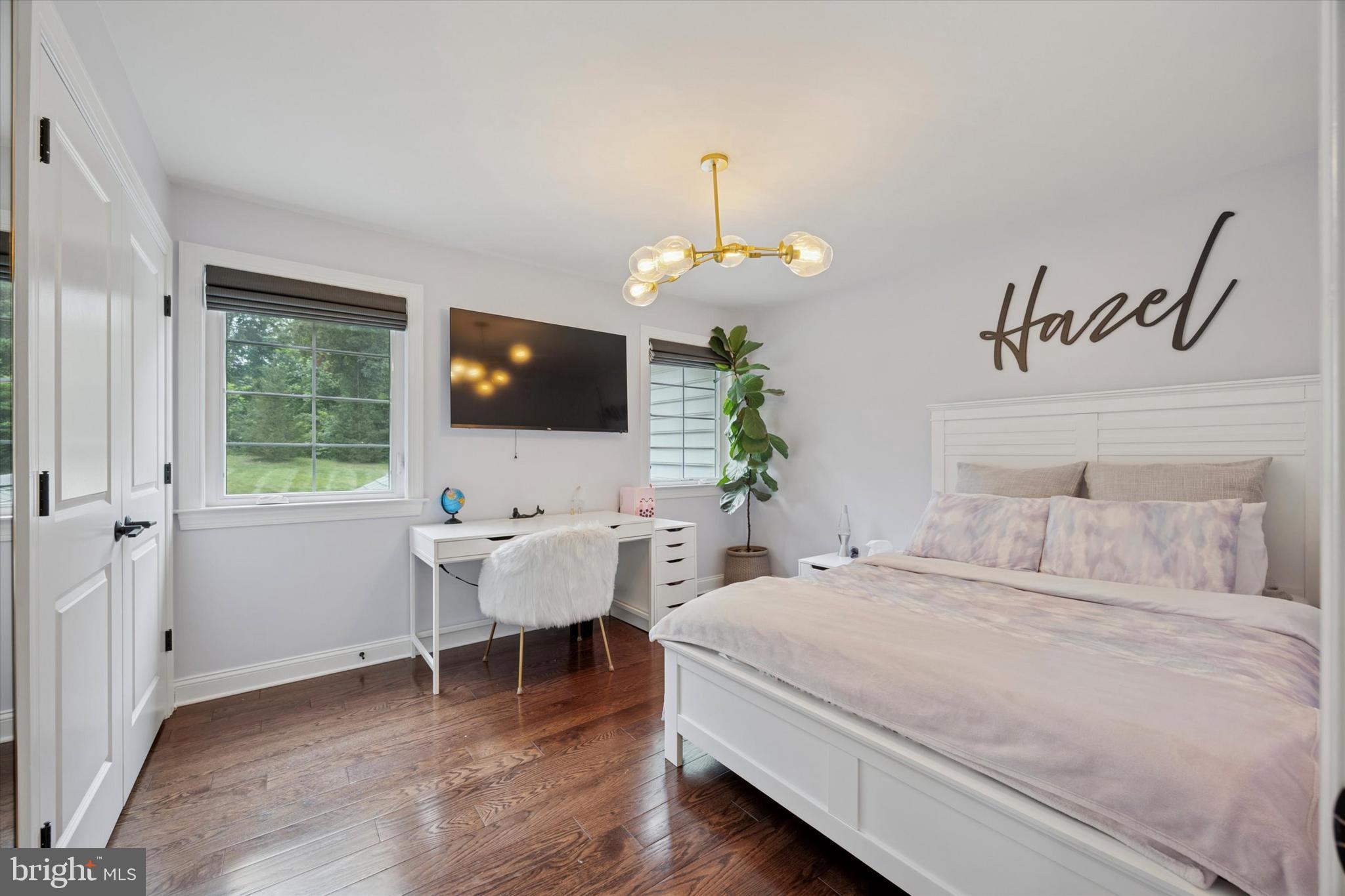 1444 Telegraph Road West Chester, PA 19380 - Photo 41 of 63 a bedroom with a bed chandelier and a flat screen tv