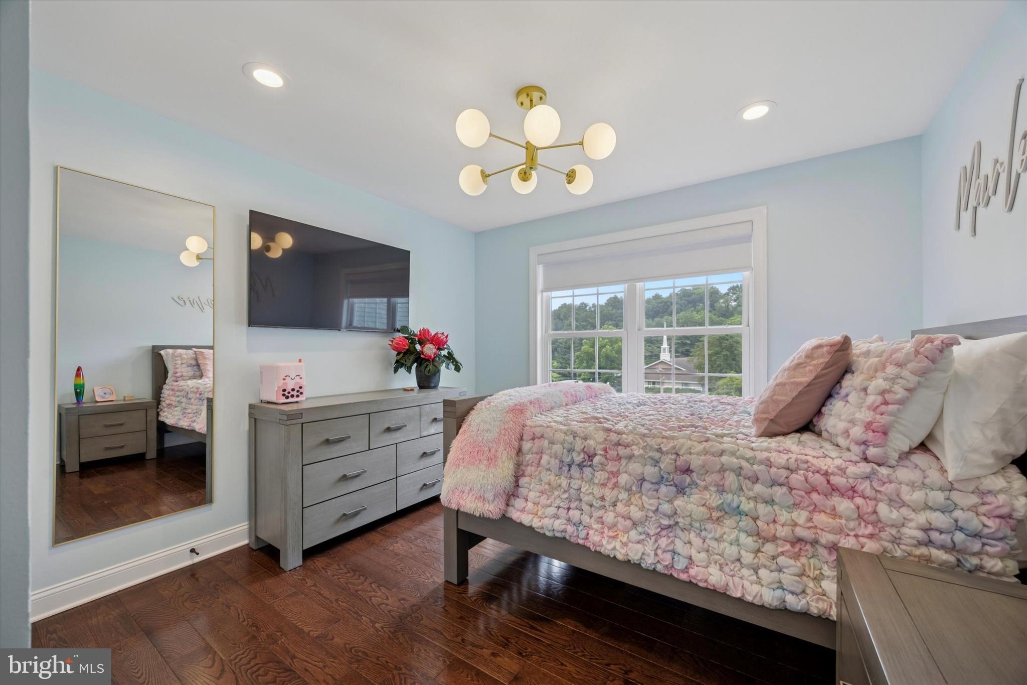 1444 Telegraph Road West Chester, PA 19380 - Photo 44 of 63 a bedroom with a bed chandelier and a flat screen tv
