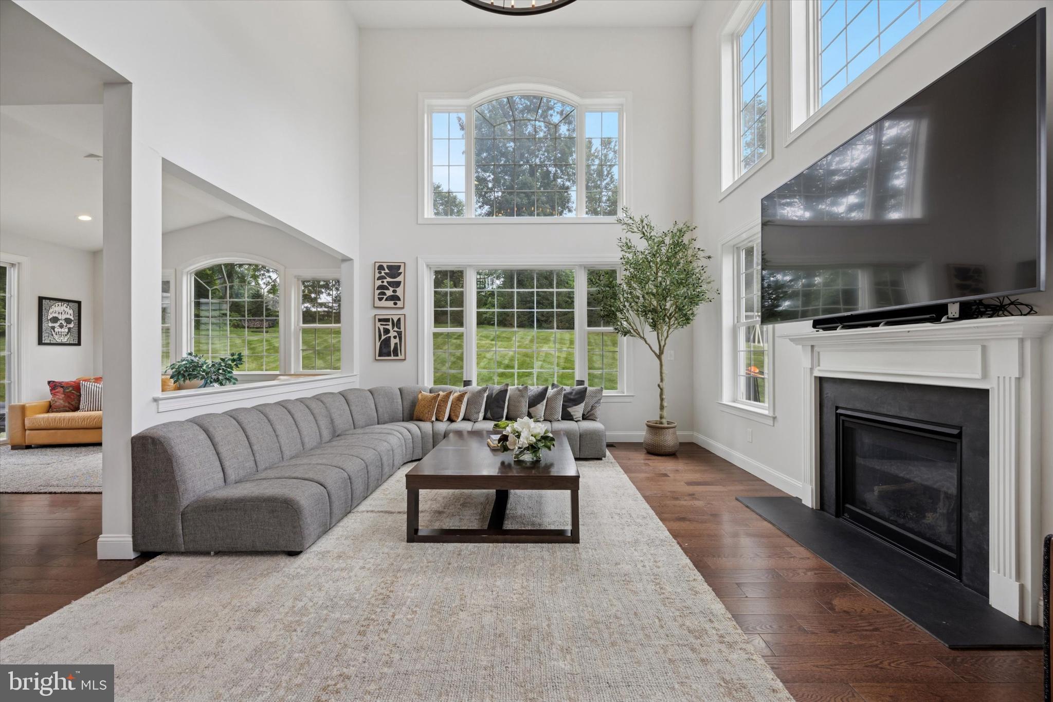 1444 Telegraph Road West Chester, PA 19380 - Photo 10 of 63 a living room with furniture a flat screen tv and a fireplace