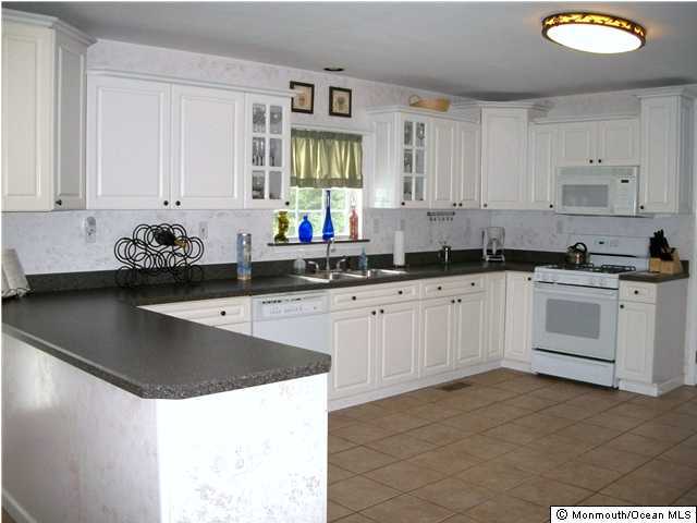 39 East Pleasant Grove Road Jackson, NJ 08527 - Photo 3 of 3 a kitchen with stainless steel appliances a sink a stove a microwave a sink and cabinets