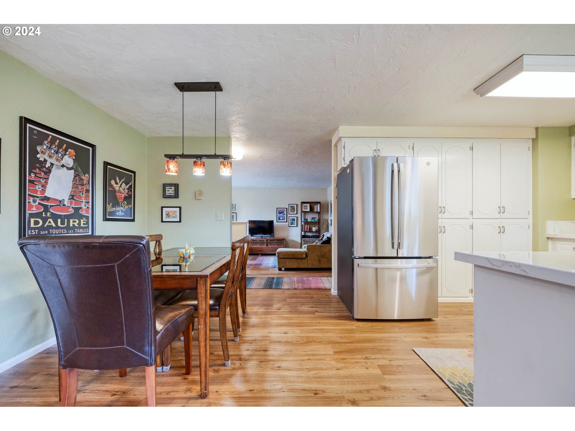 3672 Harlow Road Eugene, OR 97401 - Photo 18 of 36 a kitchen with stainless steel appliances refrigerator dining table and chairs