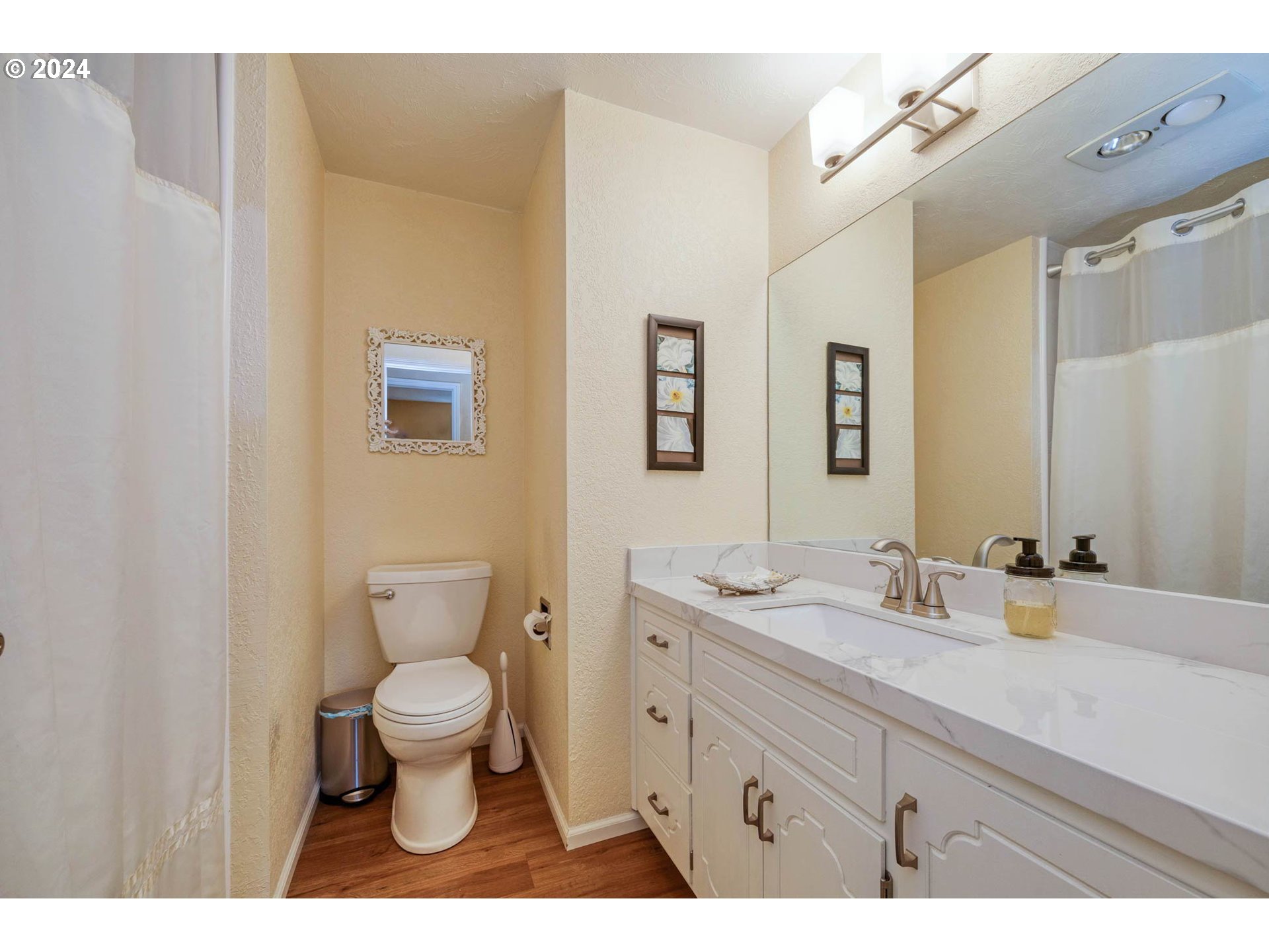 3672 Harlow Road Eugene, OR 97401 - Photo 21 of 36 a bathroom with a granite countertop toilet a sink and a mirror