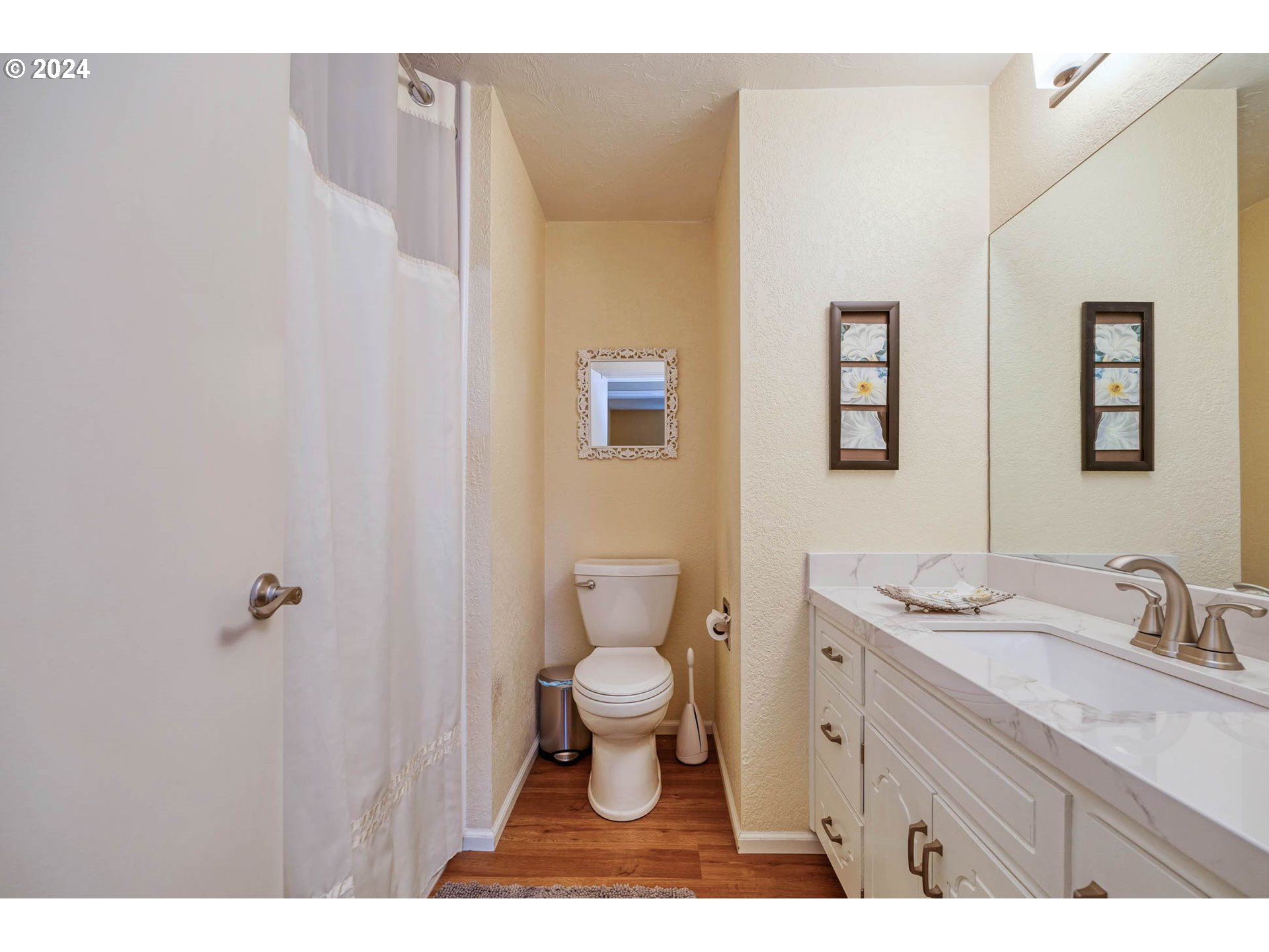 3672 Harlow Road Eugene, OR 97401 - Photo 22 of 36 a bathroom with a granite countertop sink a toilet and a mirror