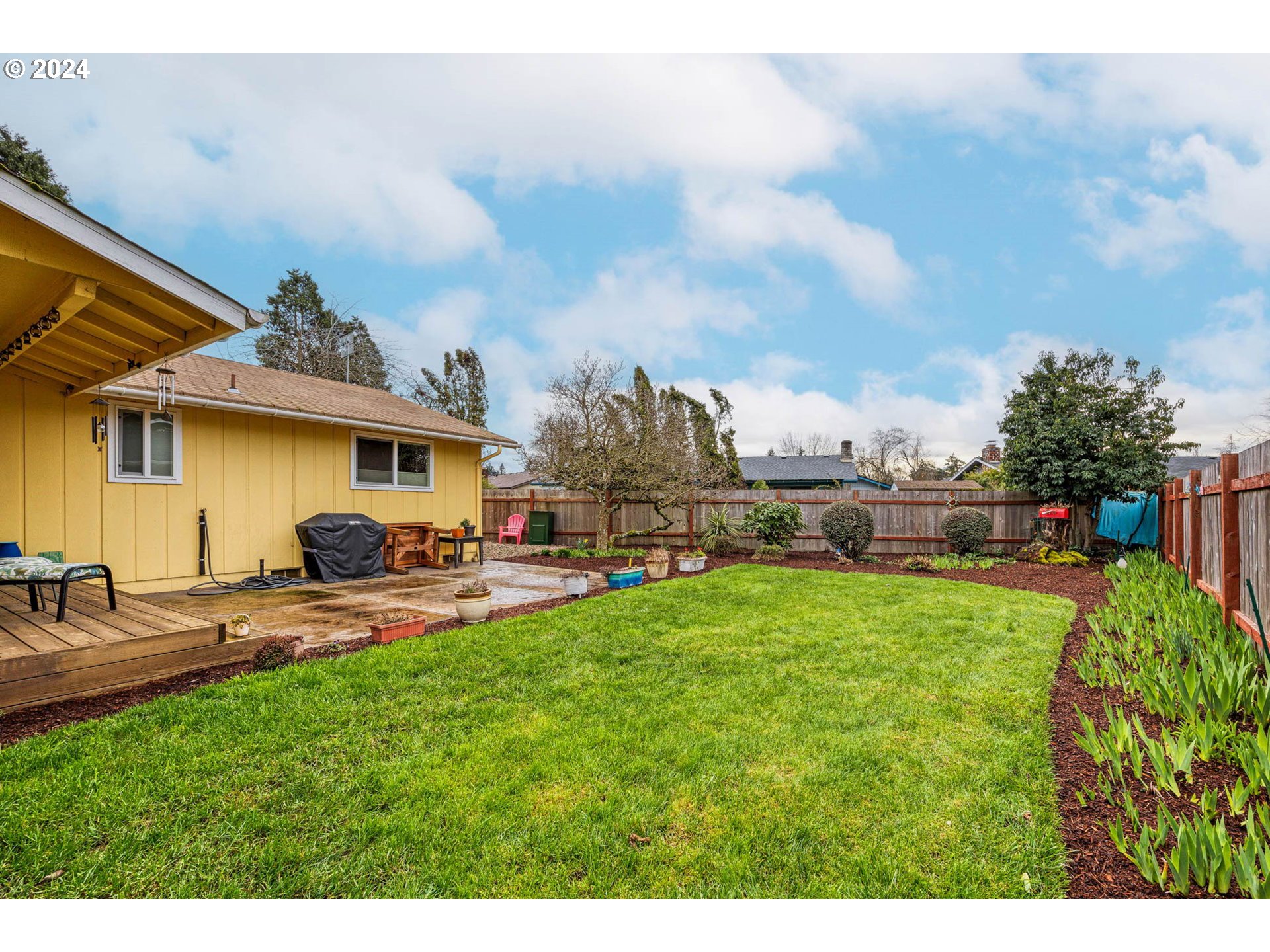 3672 Harlow Road Eugene, OR 97401 - Photo 26 of 36 a view of a patio with table and chairs under an umbrella