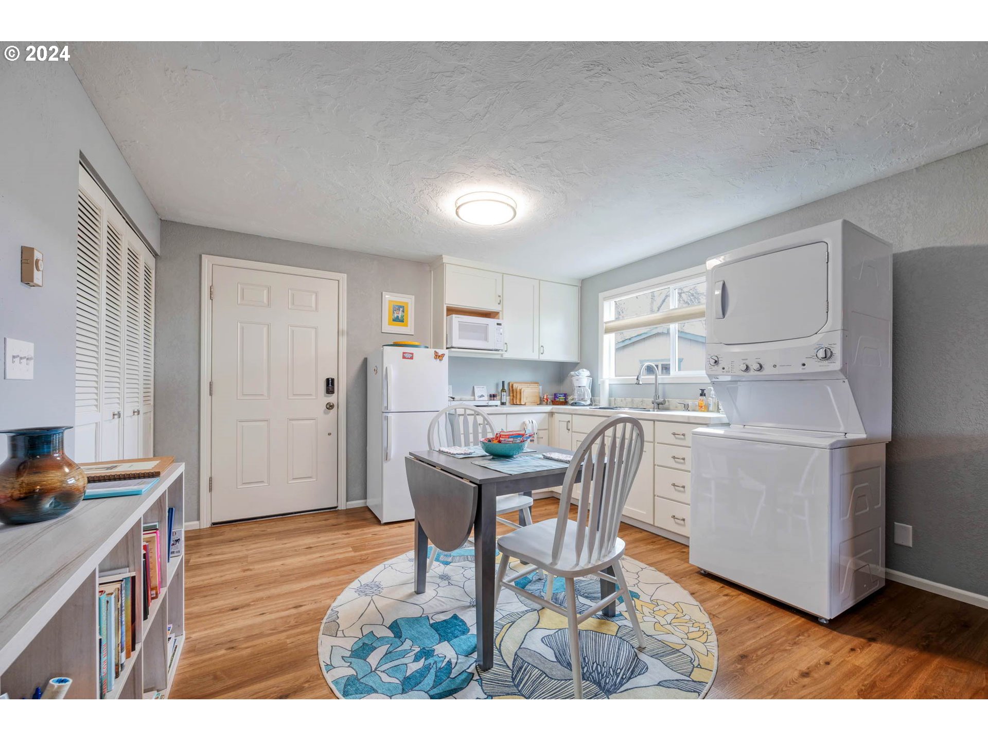 3672 Harlow Road Eugene, OR 97401 - Photo 29 of 36 a workspace with kitchen island a stove a refrigerator a sink dishwasher with a dining table and chair