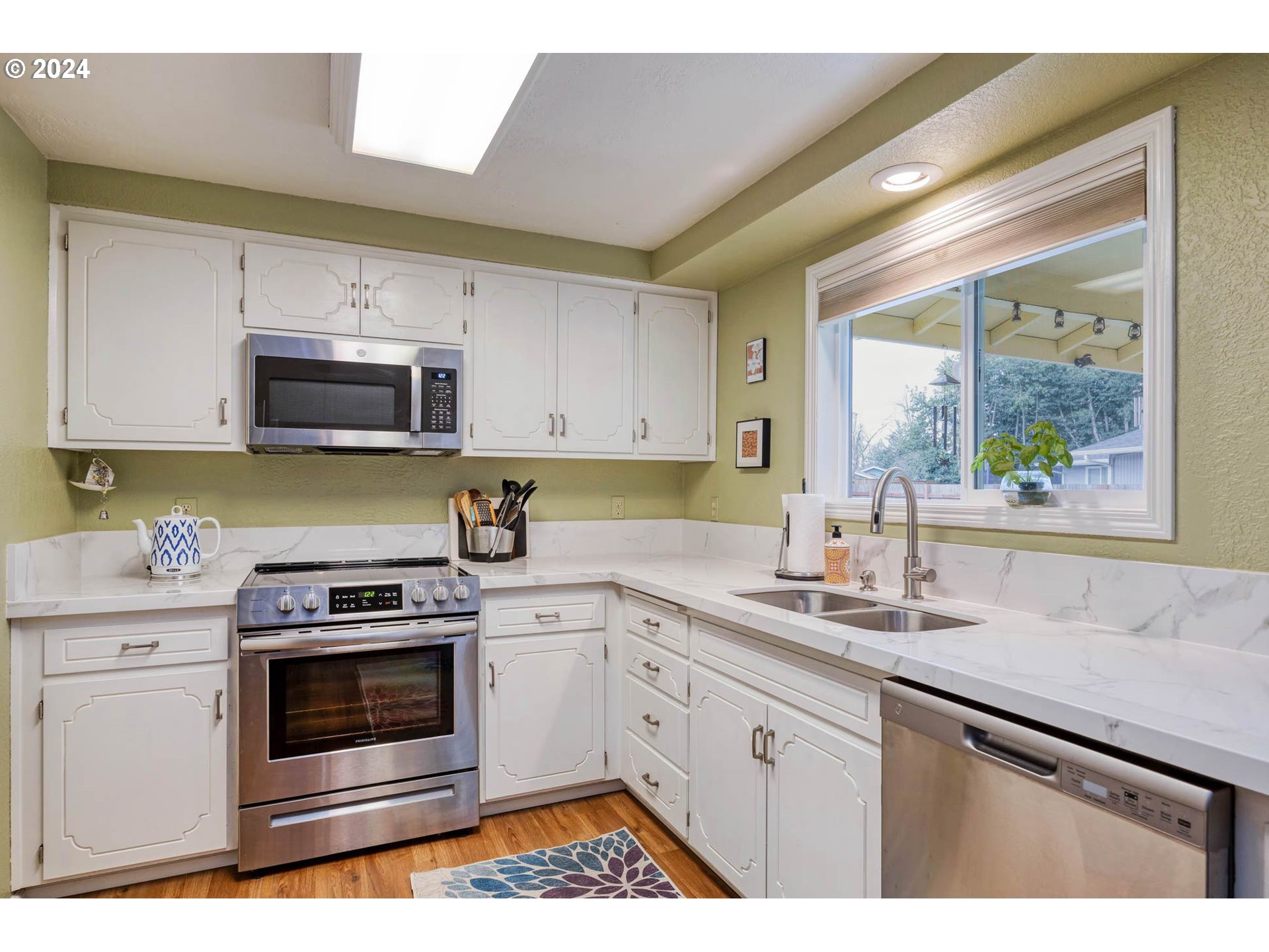 3672 Harlow Road Eugene, OR 97401 - Photo 10 of 36 a kitchen with stainless steel appliances a stove sink and microwave
