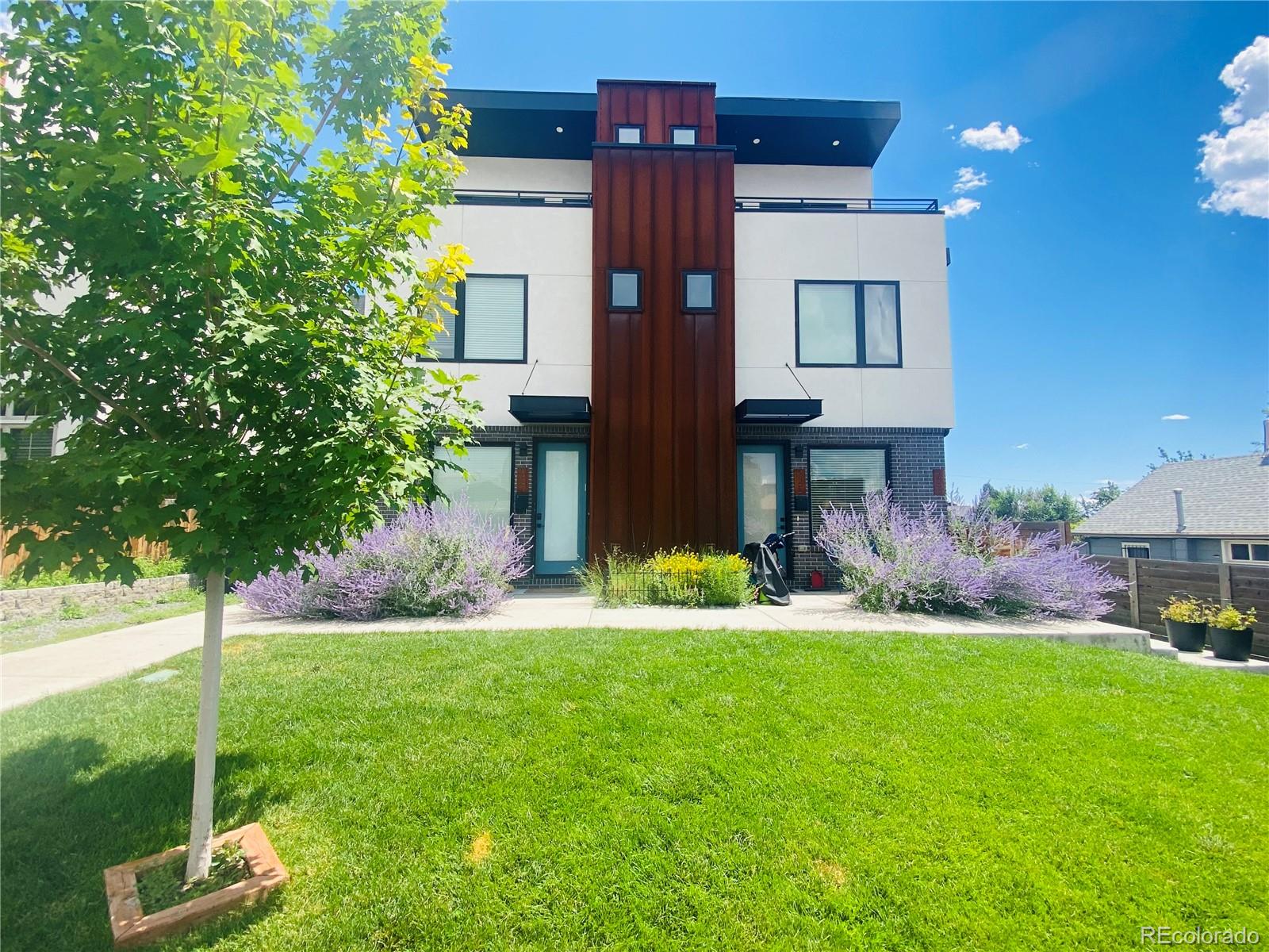 a view of a house with a yard and plants