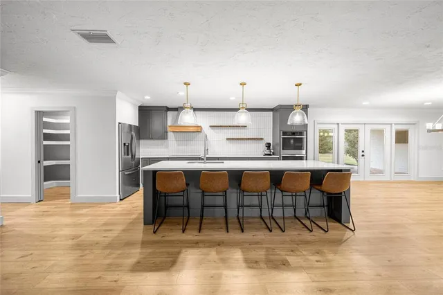 a view of kitchen with stainless steel appliances kitchen island