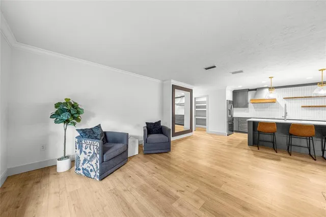 a living room with furniture and a potted plant