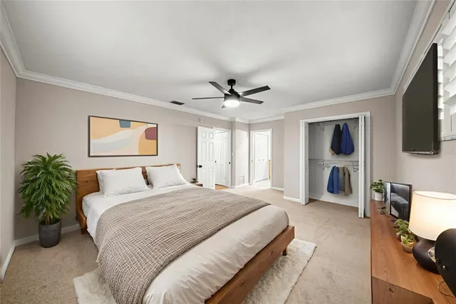 a spacious bedroom with a bed and a flat screen tv