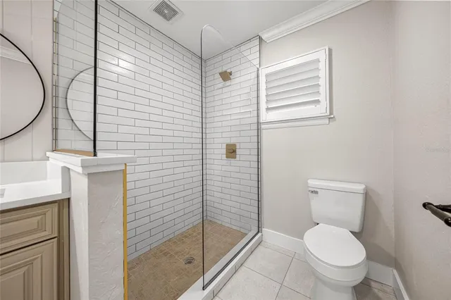 a bathroom with a toilet and a shower