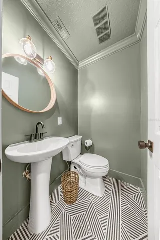 a bathroom with a sink toilet a mirror and vanity